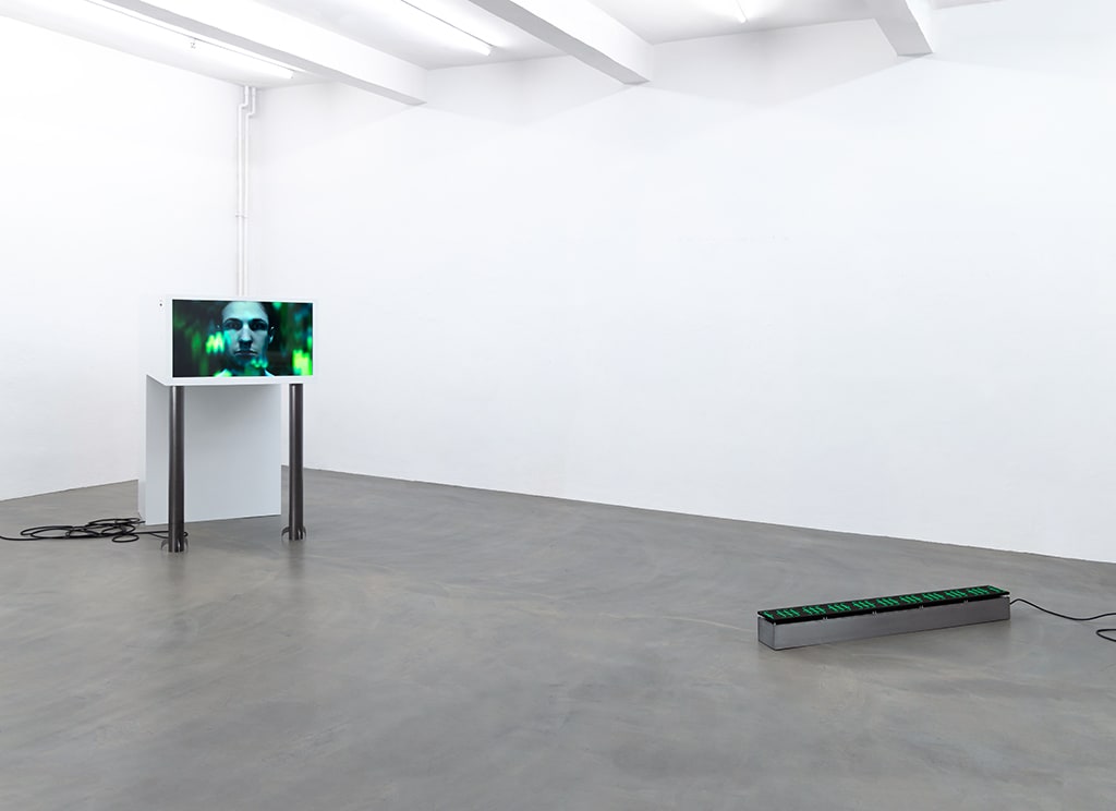 installation shot of n∰menon, left to right: large white sculpture with screen, LED Matrix on the floor